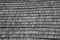 Wooden vintage shingle roof texture on historical agricultural building.