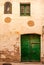 A wooden vintage window and a door on a plastered stone wall in the Spanish style.