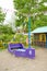 Wooden violet boat with coloful flags on sandy playground