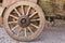 Wooden wagon with dry grass. Ancient cart with wooden wheels. Traditional rural transport. Historic rustic vehicle with dry hay.