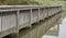 Wooden walkway built over a water pond