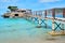 Wooden walkway leading across turquoise Mediterranean Sea