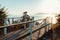 Wooden walkway leading to seashore against backdrop of sunset Sunny Summer Beach Relaxing Concept Gelendzhik