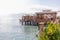 A wooden walkway leads across the blue sea in fine weather