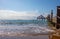 wooden walkway leads across the blue sea in fine weather