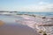 Wooden walkway leads across the blue sea in fine weather