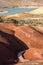 Wooden walkway between the mounds of earth cracked red at Painted Cove Trail Painted Hills