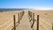 Wooden walkway over sand dunes to beach on a bright sunny day