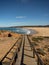 Wooden walkway path leading to deserted surf sand beach Praia da bordeira at Carrapateira Coast Algarve Portugal