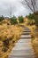 Wooden Walkway With Steps and Cloudy Sky