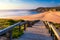 Wooden walkway to the beach Praia da Amoreira, District Aljezur, Algarve Portugal. Panorama from Amoreira beach in the Algarve