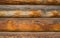 Wooden wall assembled from timber or logs. Background of horizontal logs.