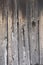 Wooden wall of a barn with the boards very deteriorated by the passage of time. rustic and abstract background. vertical position