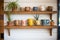 a wooden wall ledge showcasing a collection of crafted ceramic mugs