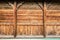 A wooden wall made of panels with a decorative imitation of columns and an arch, texture of antique boards, ancient architecture