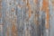 Wooden wall with orange peeling paint. Old weathered board. Shabby wood texture. Natural background