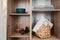Wooden wardrobe with tableware, home decor, picnic basket and cushions