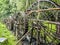 Wooden Watermill at the garden of the Yellow Dragon Cave: The wonder of the world`s caves at Zhangjiajie, Hunan Province, China