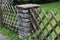 Wooden wattle fence in a garden near a rural house