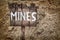 Wooden weathered warning sign for mines