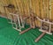 Wooden weaving tools laying under bamboo shed hut