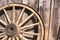 Wooden wheel against barn