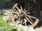 Wooden wheel from a cart. Decorative wheels for decorating lawns, exteriors and rustic interiors. Round homemade wheel