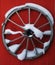 Wooden wheel on the red wall