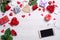 Wooden white background with hearts, gifts, red roses, smartphone and headphones