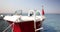 Wooden white boat is moored and floats in ocean