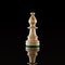 Wooden white chess bishop isolated at dark background