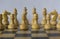 Wooden white chessmen, chess pieces stand on a chessboard in the