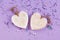 Wooden white hearts, rustic style, purple background, valentine`s day decor. Top view background.