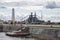 A wooden white lighthouse and a moored warship in the Petrovsky Canal. Kronstadt