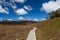 Wooden winding boardwalk in highlands of Cradle Mountain National park on bright sunny day. Tasmania, Australia.