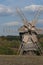 Wooden windmill. Autumnal forest.