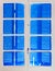 Wooden window with blue shutters closed,