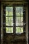 Wooden window covered in spider webs in an abandoned French farm