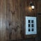 Wooden window with lighted wooden wall lanterns shining light in the dark. Space for text. Texture concept