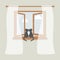 Wooden window with tulle as design element for interior of room on grey background. Outside the sky and white clouds. Pair of cats