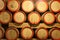 Wooden wine barrels are stored in winery cellar