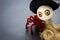 Wooden witch doll with red spider on black background