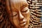 Wooden womans face sculpture created with generative AI technology