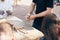 Wooden workshop. Hands carving spoon from wood, working with chisel close up. Process of making wooden spoon, chisel and shavings