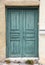 Wooden worn green door, closed. Traditional house facade, old town of Plaka, Athens Greece