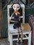 Wooden Worn-out Woman Marionette on White Chair