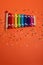 Wooden xylophone in rainbow colors for children an  on orange. Paper colorful musical notes surrounding