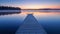 Woodenpier or jetty on lake at a foggy sunrise. Relax, vacations, or work life balance theme