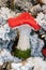 Woodland mushroom ornament with bright red cap on flocked Christmas tree