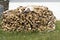 Woodpile of birch firewood stacked in a round pile and dried. Firewood for the winter. Energy and fuel for fire and heating